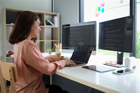 Asian Female Programmer Working At At Modern Office Developing