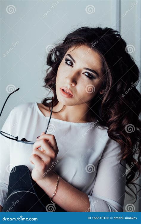 Beautiful Girl With Hat And Glasses In The Studio Curls Hairstyle Stock