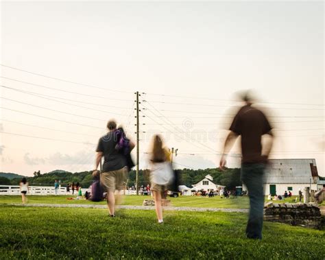 People In Slow Motion Walking Across A Park Editorial Stock Image