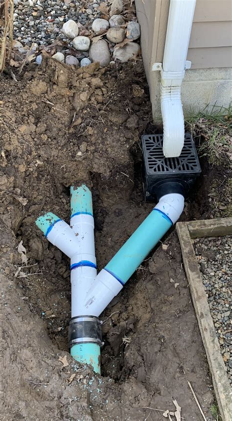 Gutter Downspout Drainage With Catch Basin And Underground Pvc Pipe To