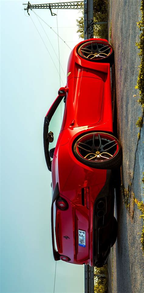 The Red Sports Car Is Parked On The Side Of The Road