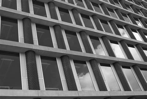 Grayscale Photo Of Gray Concrete Building · Free Stock Photo