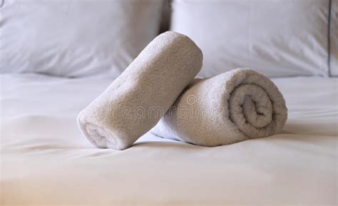 Hotel Bedroom White Fluffy Rolled Towels Linen Sheets And Pillows On