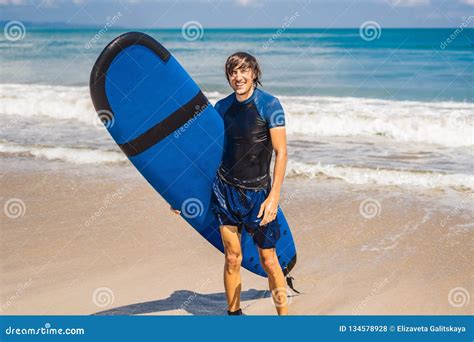 Man Carrying Surfboard Over His Head Close Up Of Handsome Guy With