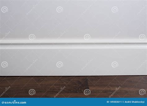 Light Matte Wall, White Baseboard and Tiles Immitating Hardwood Flooring Stock Image - Image of ...