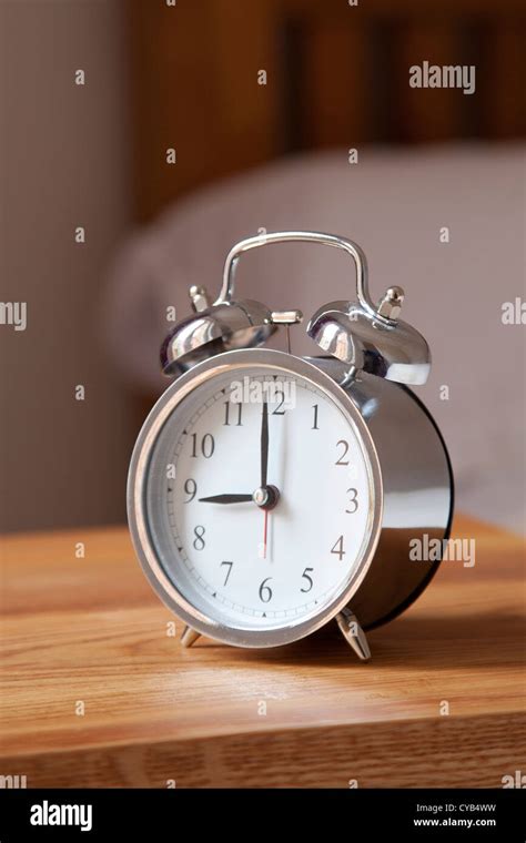 Alarm clock by bedside set at 9 AM Stock Photo - Alamy