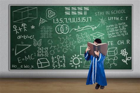 Premium Photo Girl Holding Book While Standing Against Blackboard