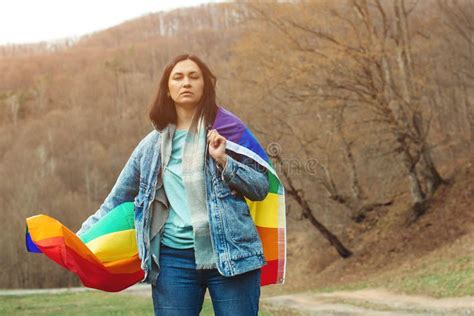 Woman Holding The Rainbow Flag On The Nature Happiness Freedom And