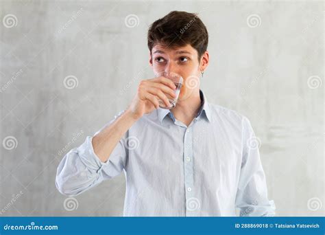 Positive Young Man Drinking Water from Glass Stock Photo - Image of portrait, person: 288869018