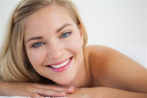 Premium Photo Beautiful Blonde Lying On Massage Table Smiling At Camera