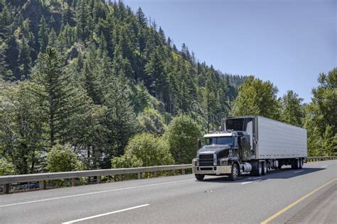 Industrial Big Rig Black Semi Truck Tractor Transporting Frozen Cargo