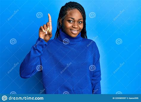 Young African American Woman Wearing Casual Clothes Smiling With An Idea Or Question Pointing