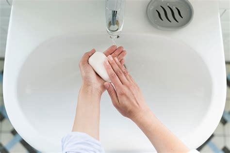 Free Photo Top View Of Person Washing Their Hands At The Sink With