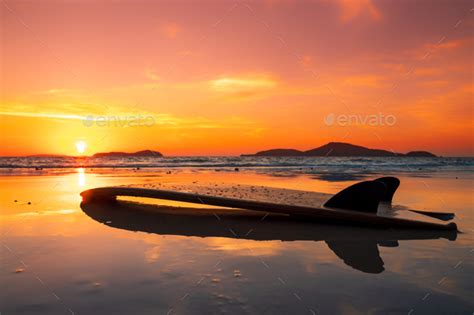 Surfboard On The Beach In Sea Shore At Sunset Time Stock Photo By Netfalls