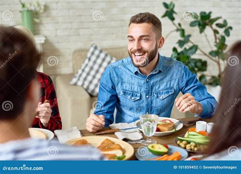 Young Man Enjoying Dinner With Friends Stock Photo Image Of