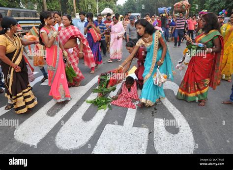 A Indian Woman Lying Prostrate Worshiping The Sun God During Chhat Puja