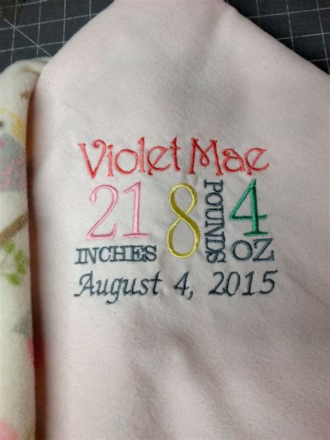 Close Up Of Custom Embroidered Birth Announcement Baby Blanket