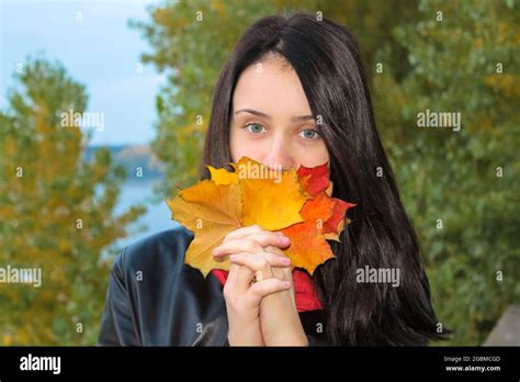 Pretty Blue Eyed Brunette Girl Covering Her Face Holding Armful Of