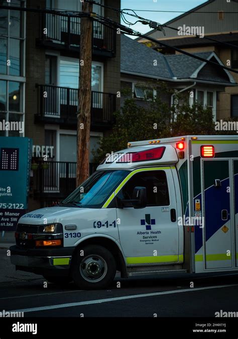 Vertical Shot Of The Alberta Health Services Ambulance At A Residential