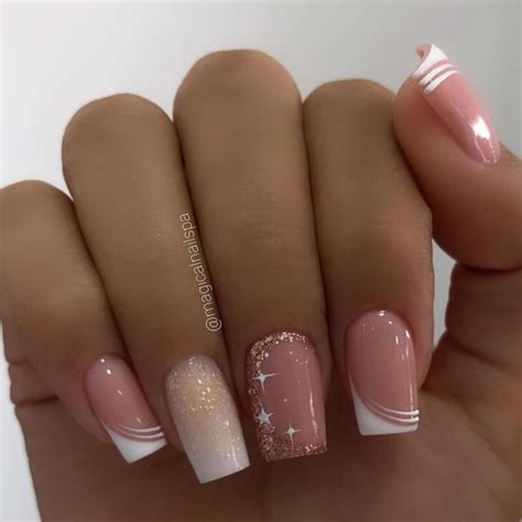 A Woman S Hand With Some Pink And White Nail Polishes On Her Nails