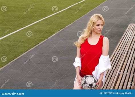 Blonde With A Ball On The Football Field In Red Uniform Stock Image Image Of Activity
