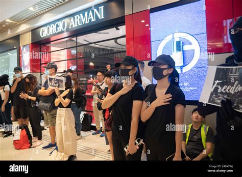 Female Protester Putting Theirs Hand On Their Hearts As They Sing Glory To Hong Kong Pro