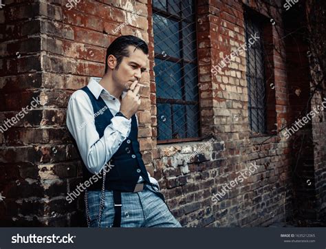 Serious Retro0styled Man Smoking Cigarette Thinking Stock Photo