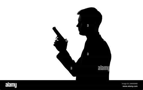 Silhouette man holding gun hi-res stock photography and images - Alamy