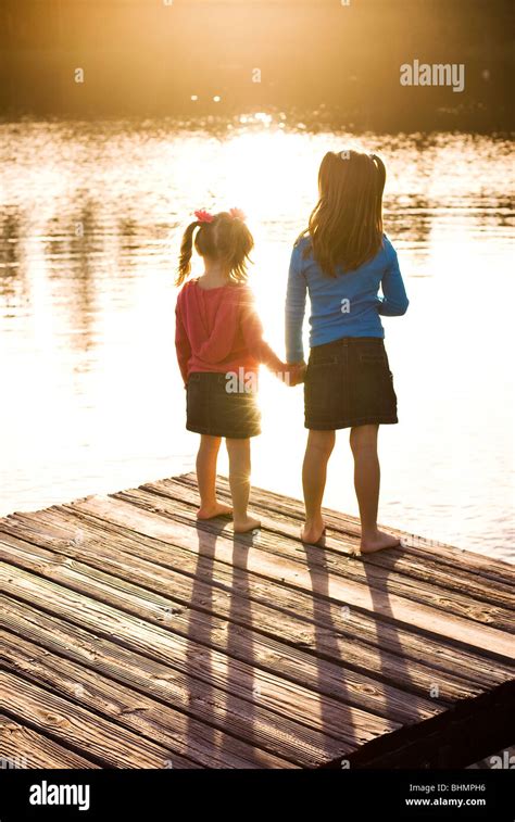 Sisters Holding Hands Stock Photo Alamy