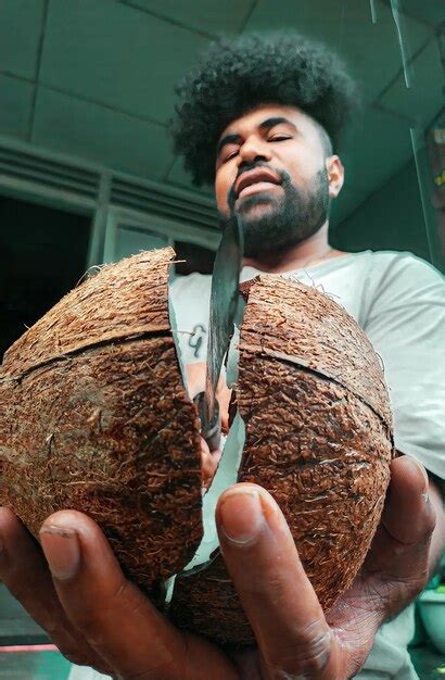 Premium Photo Young Man Holding Broken Coconut