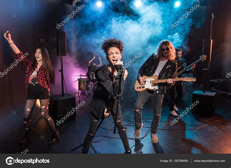 Rock band on stage — Stock Photo © TarasMalyarevich #150799494