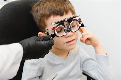 Cheerful Child Boy In Glasses Checks Eye Vision Pediatric