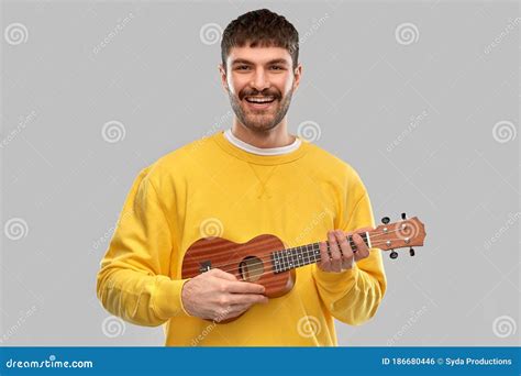 Smiling Young Man Playing Ukulele Guitar Stock Photo Image Of Casual