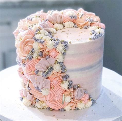 A White Cake With Pink And Blue Flowers On It