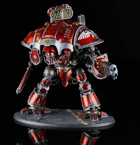 A Red And Silver Warhammer Is Standing On A Black Surface