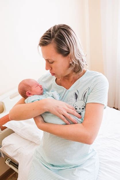 Premium Photo Newborn Baby Sleeping In Hospital Bassinet With Mom