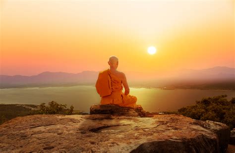 Buddhist Monk Meditating On Mountain