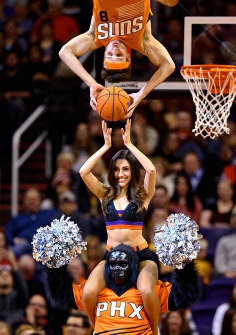 The Phoenix Suns mascot The Gorilla holds a Suns dancer on his ...