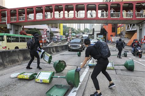 Hong Kong plunged into commuter chaos as protesters block roads and target rail services – with ...