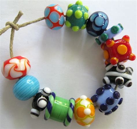 A Close Up Of A Bracelet Made Out Of Different Colored Beads On A White