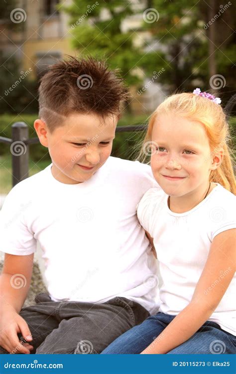 Menino E Menina Que Sentam Se Abra Ando Se Fotos De Stock Imagem