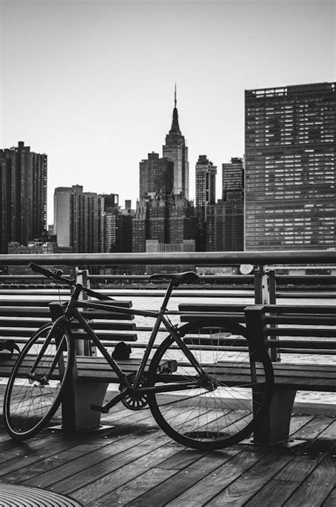 Grayscale Photograph of Bike Parked Beside Wall · Free Stock Photo