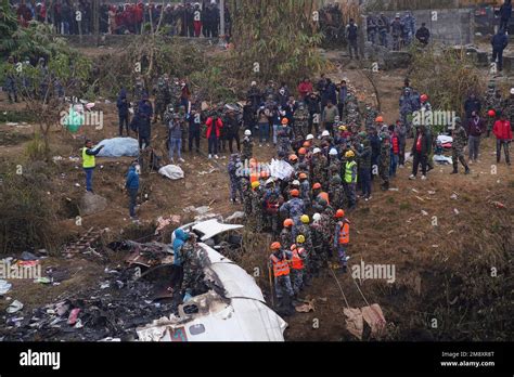 Rescuers Scour The Crash Site In The Wreckage Of A Passenger Plane In