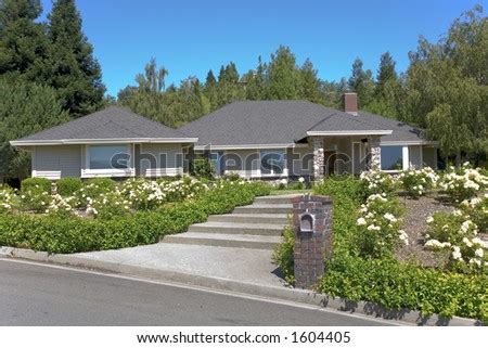 Large traditional home with beautiful landscaping. - Stock Image ...