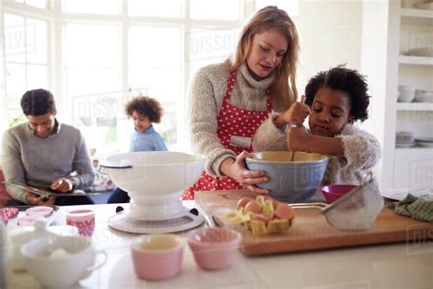 Family baking cake in kitchen at home together - Stock Photo - Dissolve