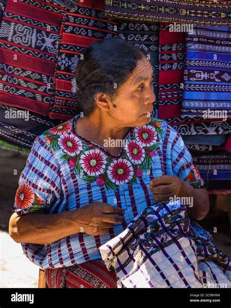 An Older Tzutujil Mayan Woman In Traditional Dress Hand Embroiders A