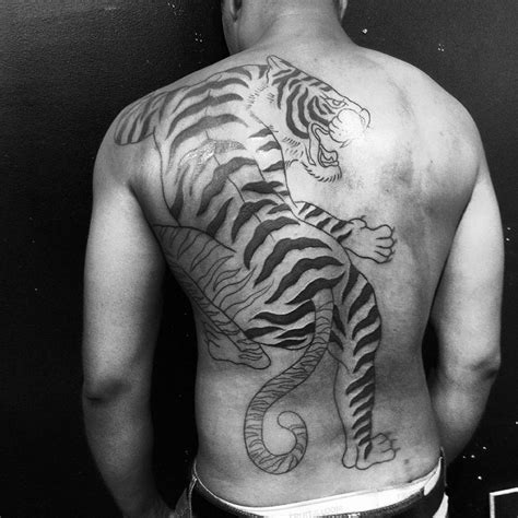 Huge tiger tattoo located on the back.