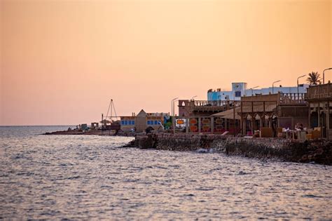 Premium Photo | Beautiful sunset in dahab seaside, cafes and orange sky in dahab, egypt