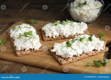 Crispy Crackers With Cottage Cheese And Microgreens On Wooden Table