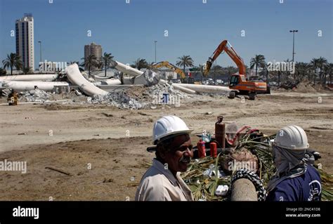 The Workers Are Seen Among The Debris Of The Pearl Square Statue In